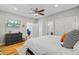Bedroom features wood floors, ensuite bath, TV, and modern dresser at 744 Gate Post Dr, Mount Pleasant, SC 29464