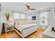 Bright bedroom with a queen-sized bed, hardwood floors, and white shiplap walls at 744 Gate Post Dr, Mount Pleasant, SC 29464