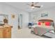 Bright bedroom featuring neutral carpet, woven headboard, ceiling fan, and ensuite access at 744 Gate Post Dr, Mount Pleasant, SC 29464