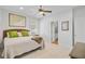 Inviting bedroom featuring a map wall decor, plush bedding, and a light ceiling fan at 744 Gate Post Dr, Mount Pleasant, SC 29464