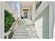 A bright and airy entryway featuring a white staircase and an inviting glass door with a decorative wreath at 744 Gate Post Dr, Mount Pleasant, SC 29464