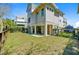 Back exterior view of elevated home with ground level parking, patio and fenced backyard at 744 Gate Post Dr, Mount Pleasant, SC 29464