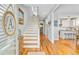 Inviting foyer featuring hardwood floors, staircase and views of the kitchen and the powder room at 744 Gate Post Dr, Mount Pleasant, SC 29464