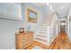 Inviting hallway with a staircase, hardwood floors, and a decorative chest of drawers at 744 Gate Post Dr, Mount Pleasant, SC 29464