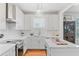 Bright kitchen features white cabinetry, subway tile backsplash, and modern appliances at 744 Gate Post Dr, Mount Pleasant, SC 29464