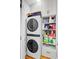 Efficient laundry space with a stackable washer/dryer and storage shelves for organization at 744 Gate Post Dr, Mount Pleasant, SC 29464