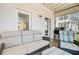 Outdoor screened porch with grill, exterior doors, and comfortable couch at 744 Gate Post Dr, Mount Pleasant, SC 29464