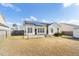 Backyard featuring a house with solar panels and an outdoor patio, creating an energy-efficient and inviting space at 7649 Fayetteville Rd, North Charleston, SC 29418