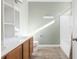 Well-lit bathroom with double vanity, built-in shelves, and tiled floor at 7649 Fayetteville Rd, North Charleston, SC 29418