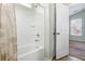 Clean white bathtub and shower area with tiled walls and showerhead at 7649 Fayetteville Rd, North Charleston, SC 29418