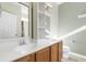 Bright bathroom featuring double sinks, mirrors, and storage shelves at 7649 Fayetteville Rd, North Charleston, SC 29418