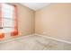 Bright bedroom featuring a large window with vibrant curtains and neutral carpet at 7649 Fayetteville Rd, North Charleston, SC 29418