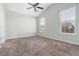 Spacious bedroom with high ceilings, neutral walls and carpet, and bright windows at 7649 Fayetteville Rd, North Charleston, SC 29418