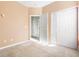 Bedroom featuring an open doorway, a closet with bi-fold doors, and neutral carpet at 7649 Fayetteville Rd, North Charleston, SC 29418
