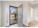 The light-filled entryway features a gray front door with an exterior view of the yard at 7649 Fayetteville Rd, North Charleston, SC 29418