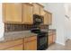 Cozy kitchen features wooden cabinets, modern appliances, and decorative backsplash at 7649 Fayetteville Rd, North Charleston, SC 29418