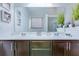 Bathroom featuring a double vanity with matching mirrors and attractive plants as decor at 7720 Kinston St, North Charleston, SC 29418