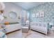 Cozy Bedroom with crib, dresser, and decorative wallpaper, art, and accessories at 7720 Kinston St, North Charleston, SC 29418