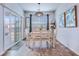 Bright dining area with sliding glass door, stylish light fixture, and seating for six at 7720 Kinston St, North Charleston, SC 29418