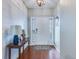 Bright foyer with elegant wood flooring, stylish console table, and shiplap accent wall at 7720 Kinston St, North Charleston, SC 29418