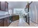 Well-equipped kitchen with dark cabinets, granite counters, stainless appliances, and an open layout at 7720 Kinston St, North Charleston, SC 29418