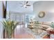Cozy living room featuring hardwood floors, a comfortable sectional sofa, and a modern ceiling fan at 7720 Kinston St, North Charleston, SC 29418