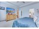 Light and airy main bedroom with a large dresser, TV, sitting area, and ensuite access at 7720 Kinston St, North Charleston, SC 29418