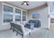 Covered outdoor patio with a ceiling fan, flatscreen TV, outdoor sofa and grill at 7720 Kinston St, North Charleston, SC 29418