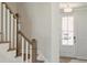 Inviting foyer featuring a staircase with wooden handrail and a front door with glass panels for natural light at 828 Alma Square Dr, Moncks Corner, SC 29461