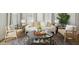 Bright living room featuring a sofa with decorative pillows, hardwood floors, and a round coffee table at 828 Alma Square Dr, Moncks Corner, SC 29461