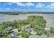 Beautiful aerial view of waterfront homes surrounded by lush green trees with a river winding through marshland at 8704 Middleton Point Ln, Edisto Island, SC 29438