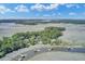 Scenic aerial shot featuring waterfront homes each with private docks along a calm river and expansive marshland at 8704 Middleton Point Ln, Edisto Island, SC 29438