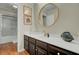 Bathroom featuring a single sink vanity with framed artwork and wood floors at 8704 Middleton Point Ln, Edisto Island, SC 29438