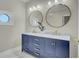 Modern bathroom with a double sink vanity with gold fixtures and round mirrors at 8704 Middleton Point Ln, Edisto Island, SC 29438