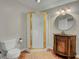 Bathroom showcasing a vanity, round mirror, a toilet, and a framed glass shower enclosure at 8704 Middleton Point Ln, Edisto Island, SC 29438