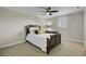 Neutral bedroom featuring a ceiling fan, bed with decorative pillows, and a side desk at 8704 Middleton Point Ln, Edisto Island, SC 29438