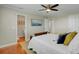 Bedroom featuring a ceiling fan, bed with decorative pillows, and an ensuite bathroom at 8704 Middleton Point Ln, Edisto Island, SC 29438