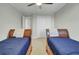 Bedroom with hardwood floors featuring two twin beds and large closet at 8704 Middleton Point Ln, Edisto Island, SC 29438