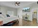 Comfortable bedroom with ceiling fan, television, and hardwood flooring at 8704 Middleton Point Ln, Edisto Island, SC 29438