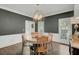 This dining room features a round table, hardwood floors, natural light, and wainscoting at 8704 Middleton Point Ln, Edisto Island, SC 29438