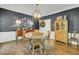 This dining room offers a round table, four chairs, hardwood floors, and decorative elements at 8704 Middleton Point Ln, Edisto Island, SC 29438