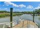 Private dock area with boat lift, featuring scenic marsh views and access to open water at 8704 Middleton Point Ln, Edisto Island, SC 29438