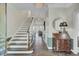 Inviting entryway with hardwood floors, staircase and elegant decor at 8704 Middleton Point Ln, Edisto Island, SC 29438