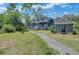 Inviting home exterior featuring a wide porch, landscaped yard, and a walkway to the entrance at 8704 Middleton Point Ln, Edisto Island, SC 29438