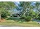Manicured front yard with mature trees and a beautiful home exterior at 8704 Middleton Point Ln, Edisto Island, SC 29438