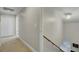 Hallway with staircase leading to a closed white doors and carpeted floor at 8704 Middleton Point Ln, Edisto Island, SC 29438