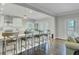The open-concept kitchen features an island with seating, hardwood floors, and stainless steel appliances at 8704 Middleton Point Ln, Edisto Island, SC 29438