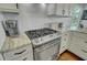 Close-up of kitchen with modern gas range and granite countertops at 8704 Middleton Point Ln, Edisto Island, SC 29438