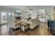Open-concept living room with built-ins, a fireplace, hardwood floors, and access to the backyard at 8704 Middleton Point Ln, Edisto Island, SC 29438