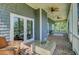 Spacious screened-in porch offering brick floors, ceiling fans, and ample seating to enjoy the outdoors at 8704 Middleton Point Ln, Edisto Island, SC 29438